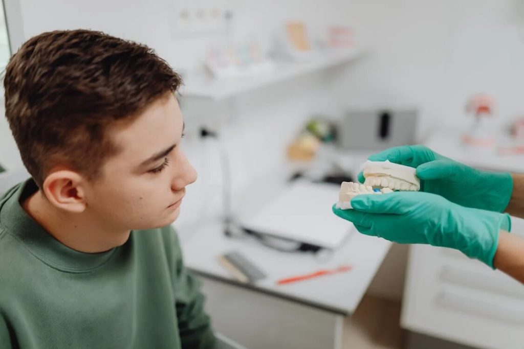  A denture professional explains how the denture works to a patient